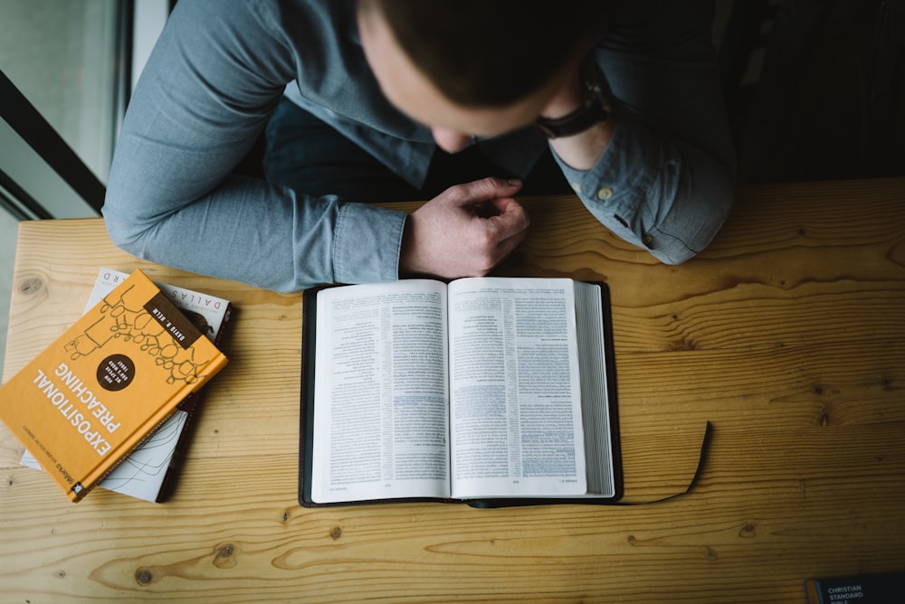 white book on brown wooden table