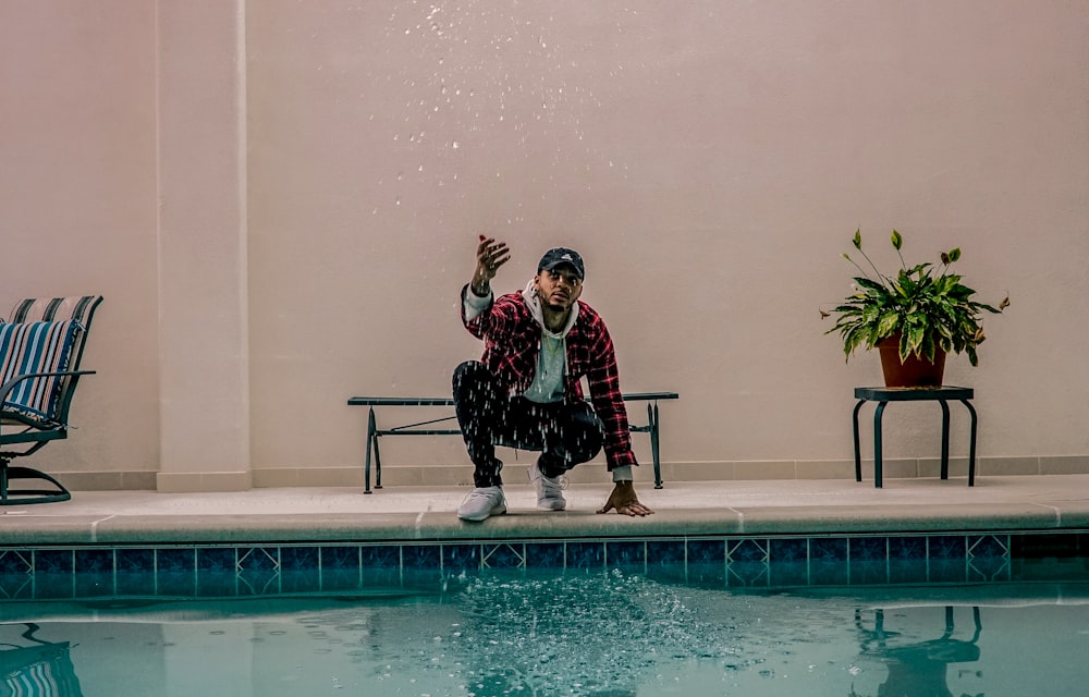 man sitting in front of underworld pool