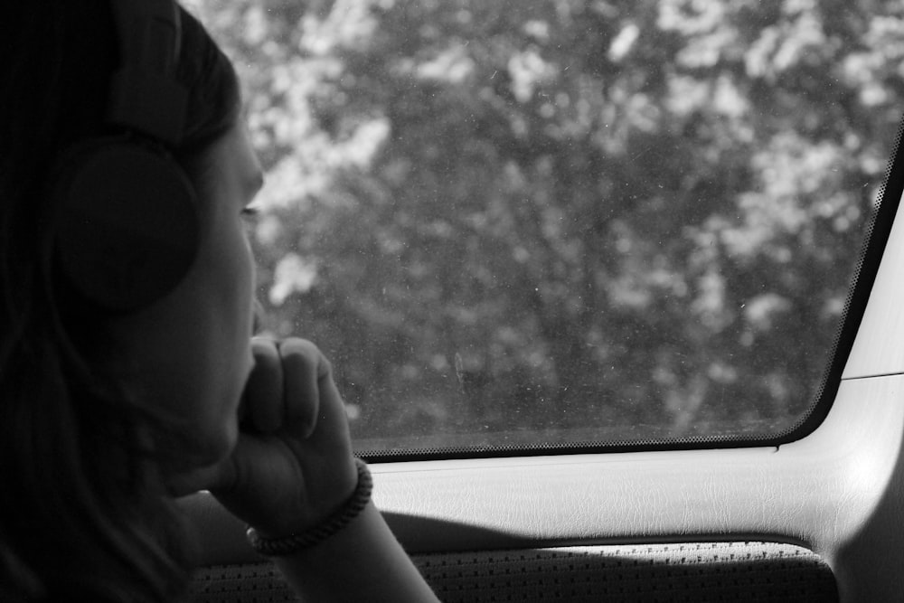 grayscale photo of woman inside car