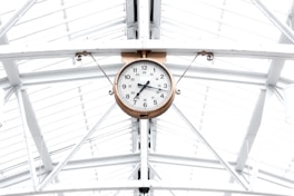 round gold and white analog clock reading at 7:10
