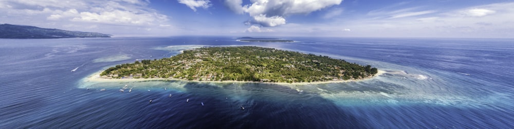 aerial photo of island under cloudy sky at daytime