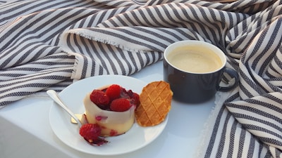 A cozy table setting featuring brigadeiros and mousse de maracujá in small glass cups.