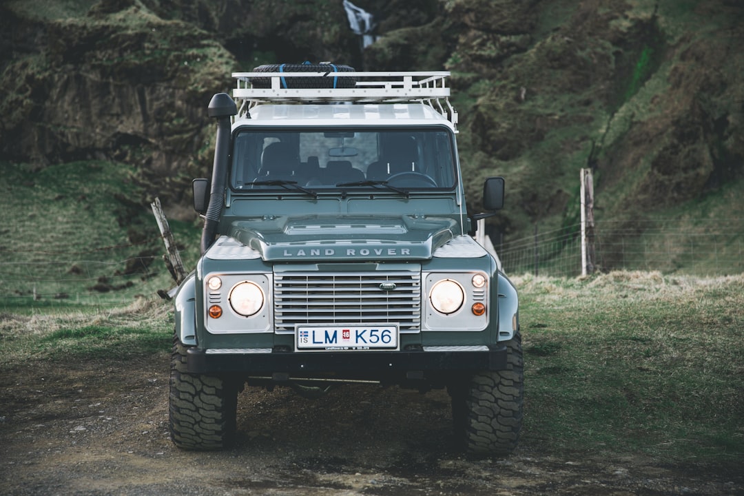 gray Land Rover vehicle parked near mountain