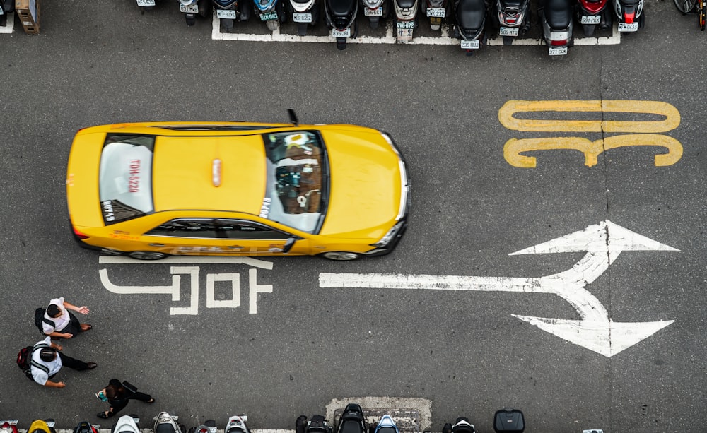 yellow racing car on gray pave road