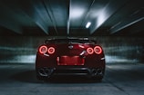 red sports car on concrete flooring