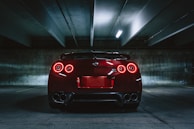 red sports car on concrete flooring