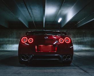 red sports car on concrete flooring