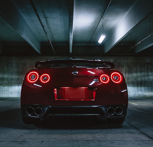 red sports car on concrete flooring