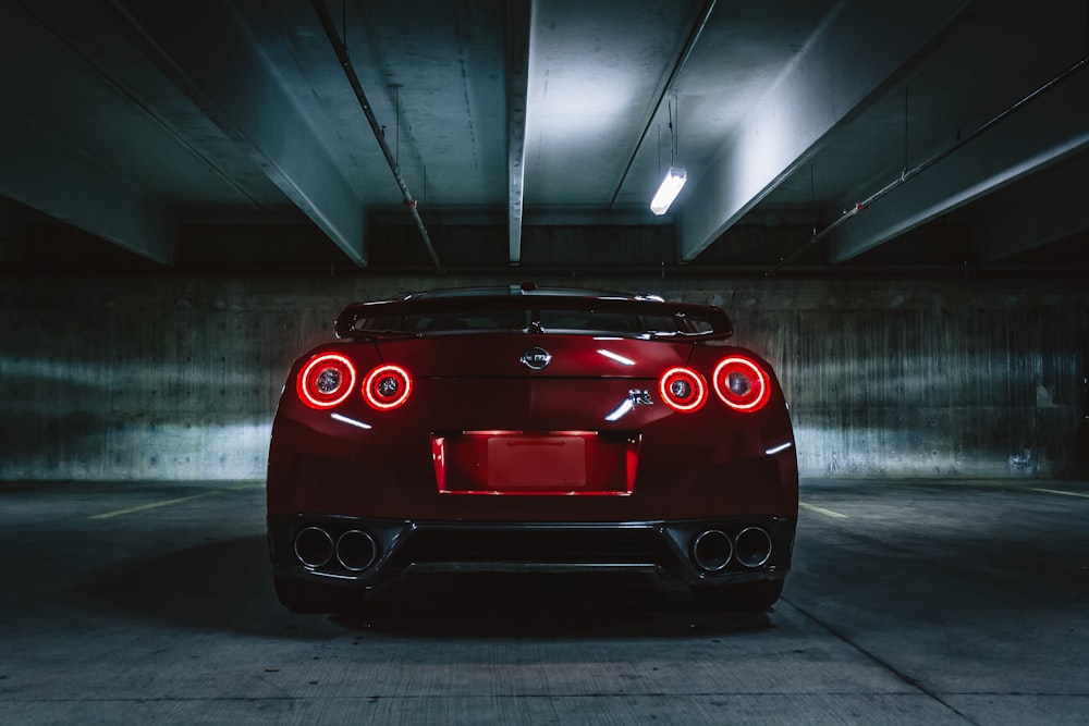 red sports car on concrete flooring