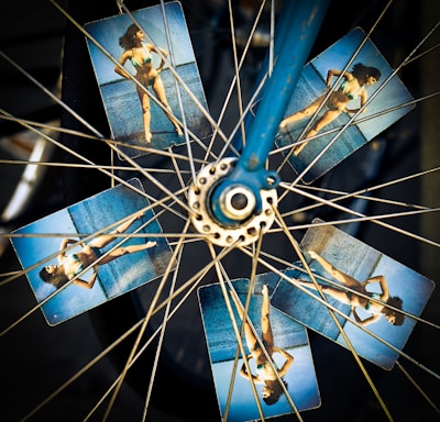 blue and grey bicycle wheel with photo of woman