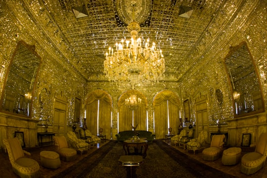 crystal and gold chandelier turned on in Golestan Palace Iran