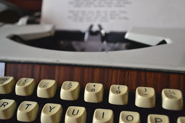 A close-up of a vintage typewriter with blood-red ink on the keys.
