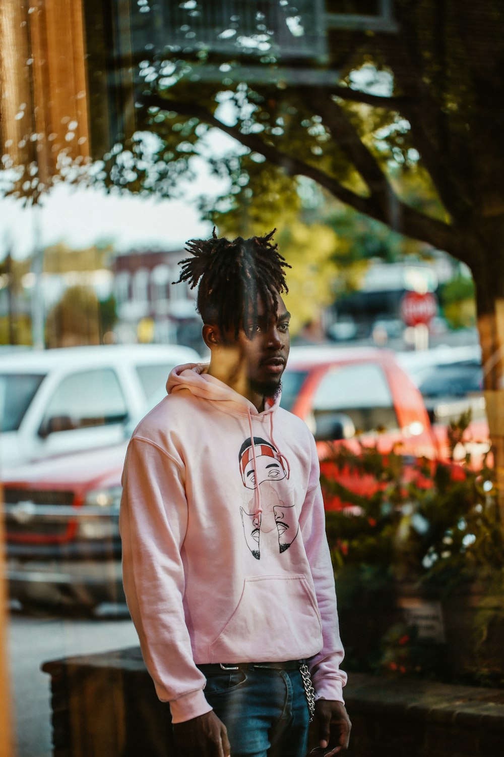 man wearing pink pullover hoodie