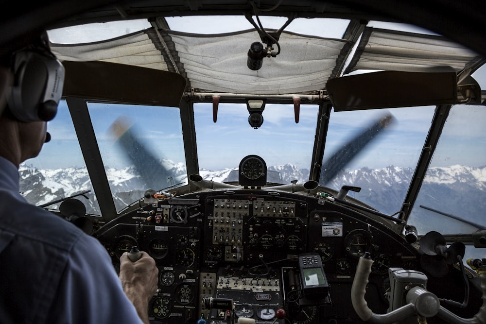 pilot driving plane during daytime