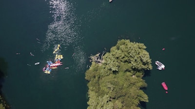 Drone view of a group of friends kayaking through turquoise waters in Búzios