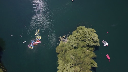 Drone view of a group of friends kayaking near the rocky shores of Búzios.