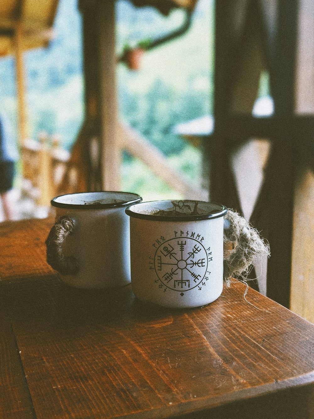 two white mugs on table