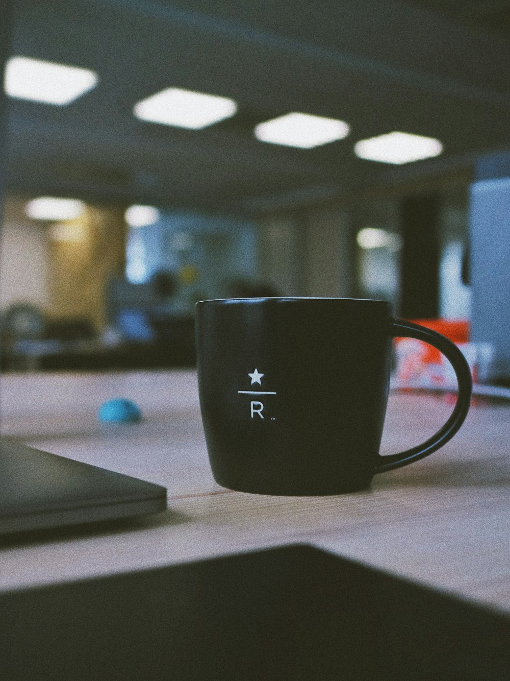 black ceramic mug on wooden table