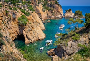boats on water between mountains and trees