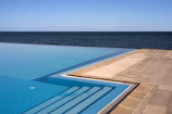 A pristine infinity pool blending seamlessly into the ocean horizon at a high-end resort.