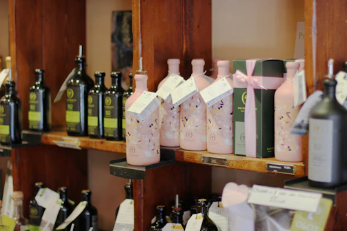 Elegant bottles of extra virgin olive oil displayed on a marble countertop with olive branches.