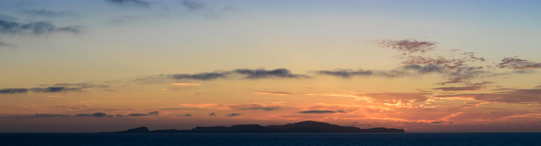 A serene coastal view of Reunion Island at sunset, symbolizing hope and connection.