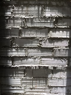 A striking close-up of a textured concrete wall bathed in warm morning light, highlighting industrial elegance.