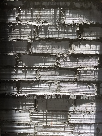 A striking close-up of a textured concrete wall bathed in warm morning light, highlighting industrial elegance.