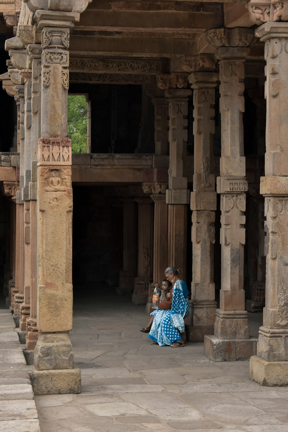 woman and child sitting inside building