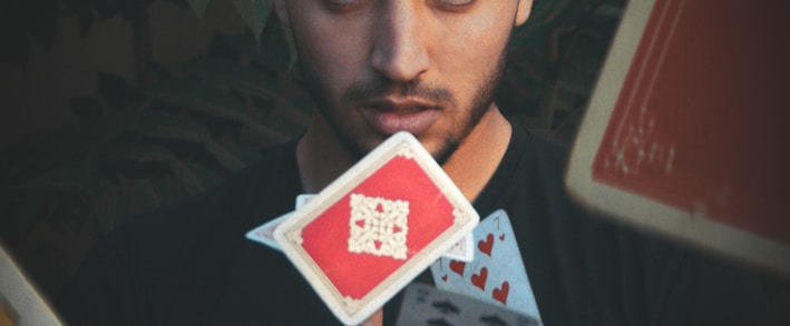 man throwing playing cards