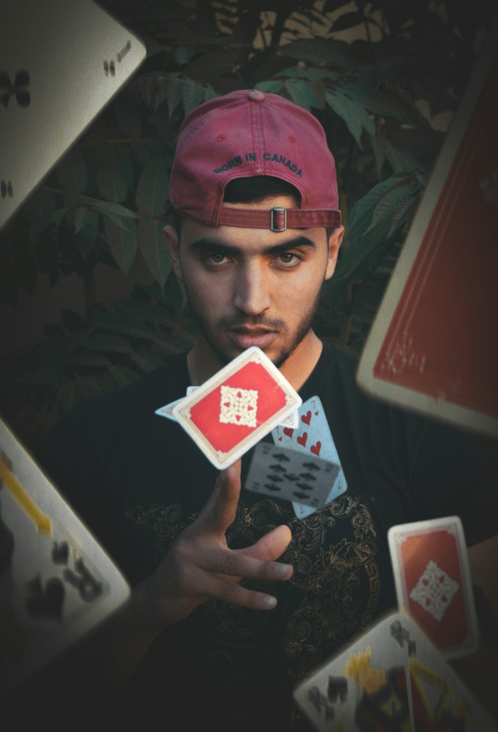 man throwing playing cards