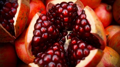 close-up photo of sliced pomegranate fruit teams background