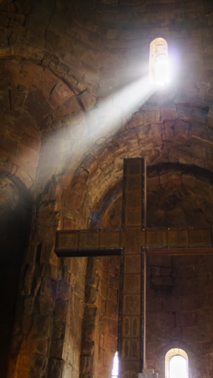 Sunlight streaming through stained glass windows inside a warm, inviting church sanctuary.