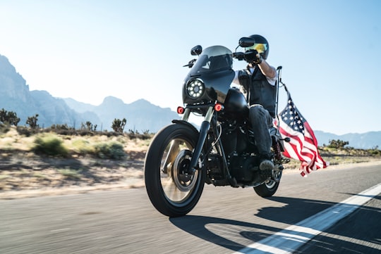 man riding motorcycle with USA flag on back in Las Vegas United States