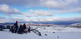A group discussion between researchers and indigenous leaders in a snowy landscape.