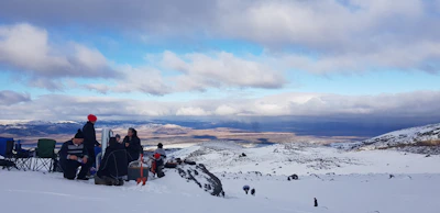 A group discussion between researchers and indigenous leaders in a snowy landscape.
