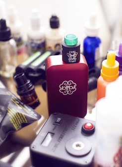 red box mod vape beside e-juice bottles