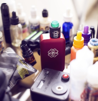 red box mod vape beside e-juice bottles