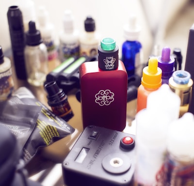 red box mod vape beside e-juice bottles