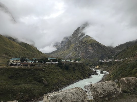 houses near river and mountains in Mana India