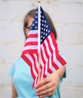 person holding USA Flag