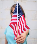 person holding USA Flag