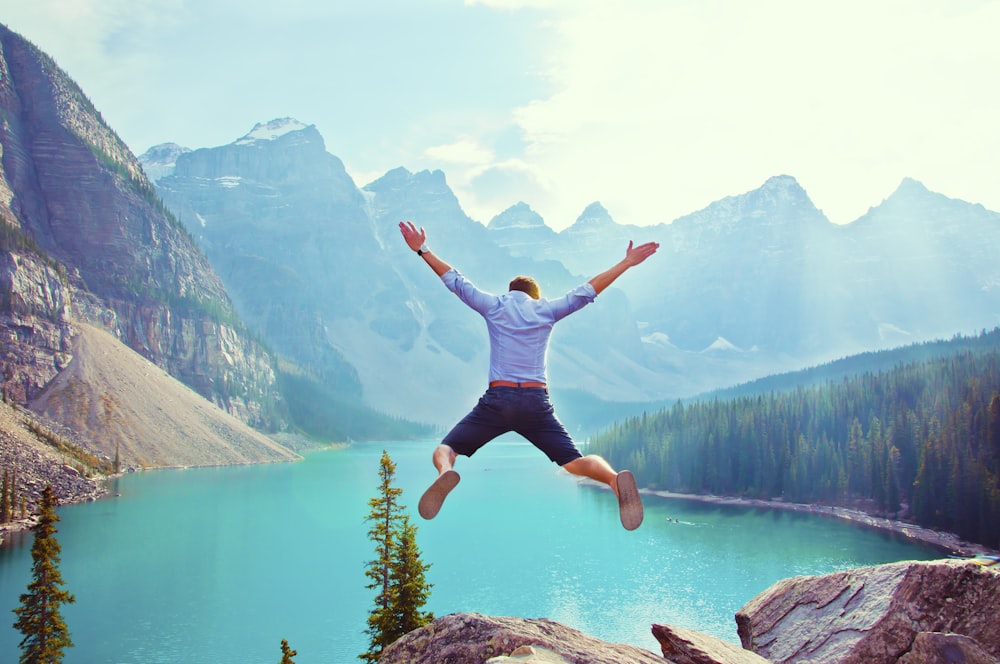 Photo Of Man About To Jump From Cliff Photo Free Moraine Lake Lodge Image On Unsplash