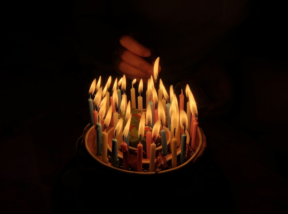 person touching assorted candles