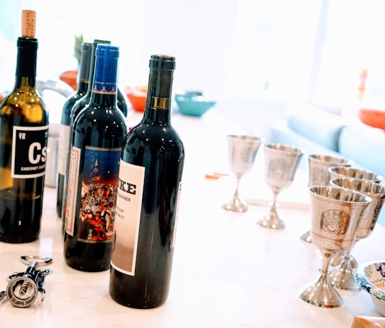 Display of premium promotional items for winery events including engraved corkscrews and wine gifts.