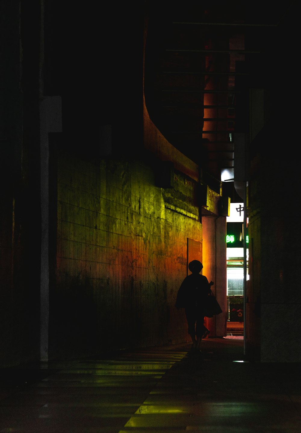 silhouette of person walks on hallway