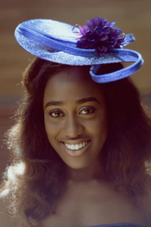 Editorial style shot of the model’s rose pink fascinator hat blending subtly with the purple and indigo sky hues.