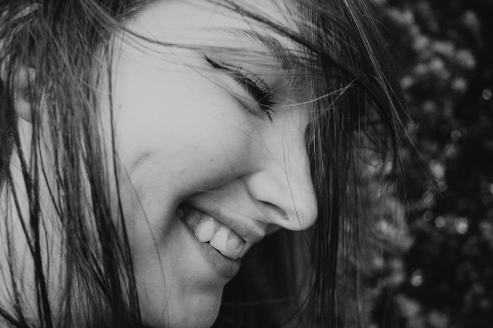 grayscale photo of smiling woman