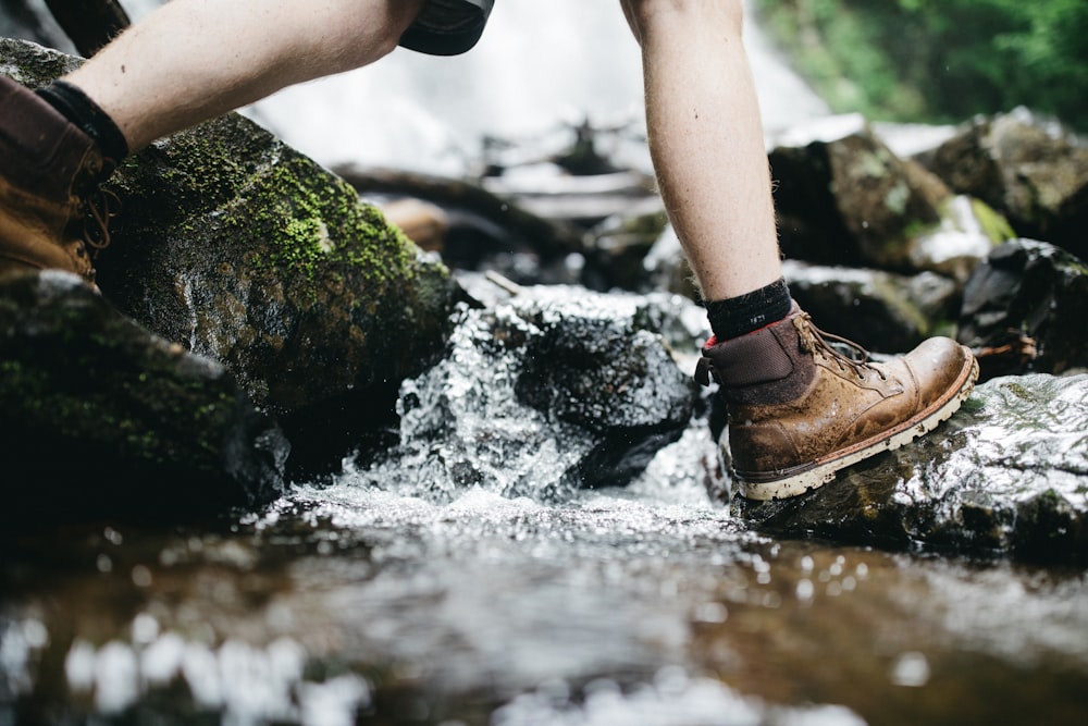 person stepping on rock