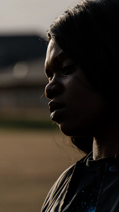 A close-up of a thoughtful executive, with subtle shadows emphasizing their determination and vision.